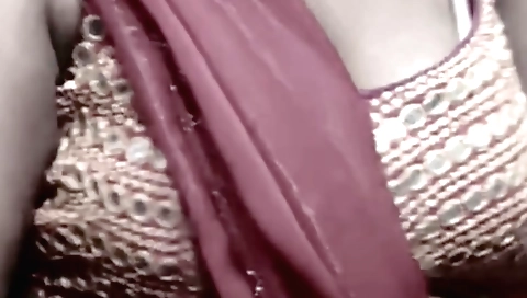 Indian mature woman plays with her boobs in a solo