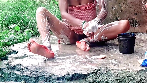 Solo female bhabhi bhabdi plays with her legs in an outdoor area