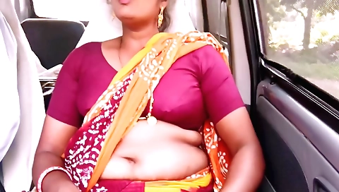 Amateur hot woman with nice figure driving a car on road