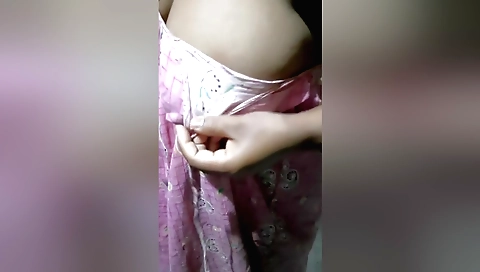 Indian brunette is naked and showing her big tits in bed