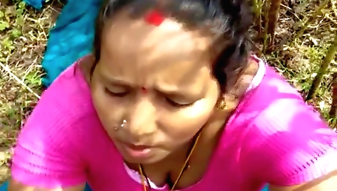 Indian girl with a tan in a white tank top is having oral sex